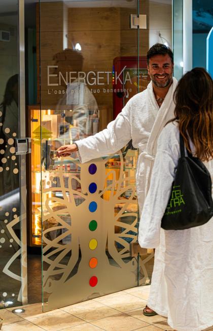 Two people in robes enter a spa called Energetika.