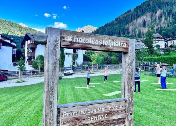 Outdoor yoga class amidst the mountains of Trentino.