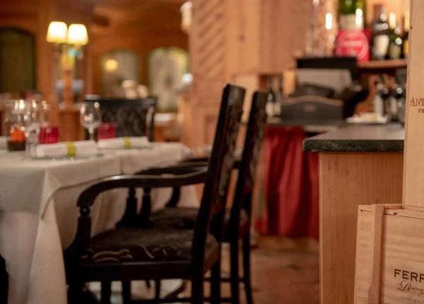 Elegant restaurant with Antica Fratta and Ferrari wine crates.