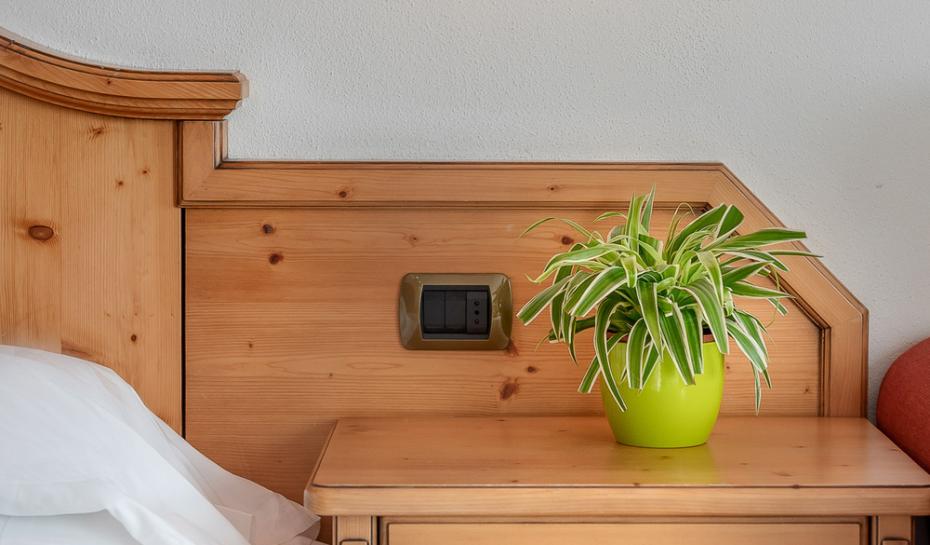 Camera da letto con armadio in legno, letto matrimoniale e decorazioni semplici.