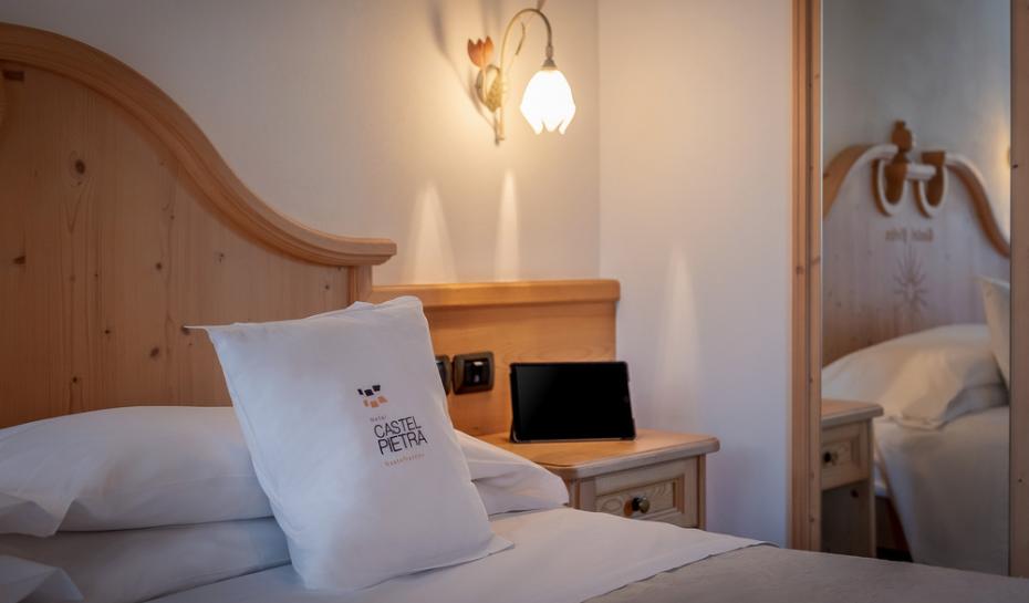 Cozy hotel room with pillow and soft lighting.