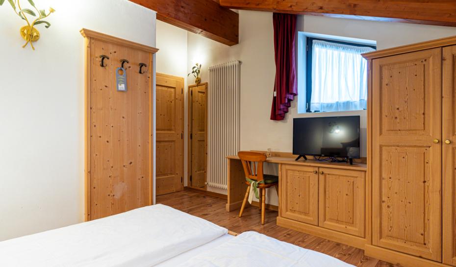 Cozy room with wooden furniture, TV, and window.